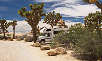 A class B RV parked in the desert