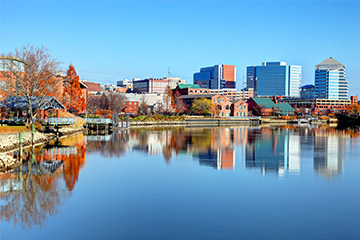 A view of a lake in Delaware with buildings in the background