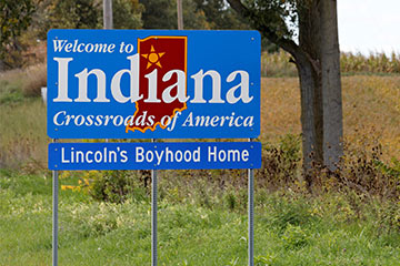A blue welcome Indiana road sign