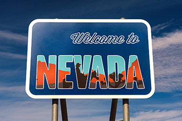 A blue welcome to Nevada road sign