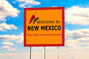 An orange welcome to New Mexico road sign