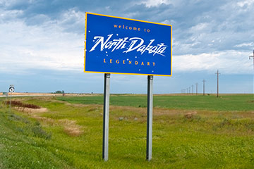 A blue state of North Dakota road sign