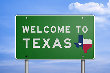 A green Welcome to Texas road sign