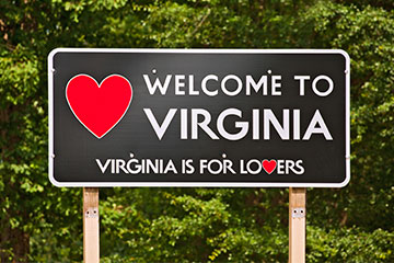 A black Welcome to Virginia road sign