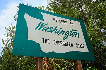 A green Welcome to Washington road sign